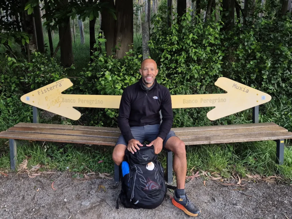 Simon sitting on a bench in Galicia on the Camino de Santiago