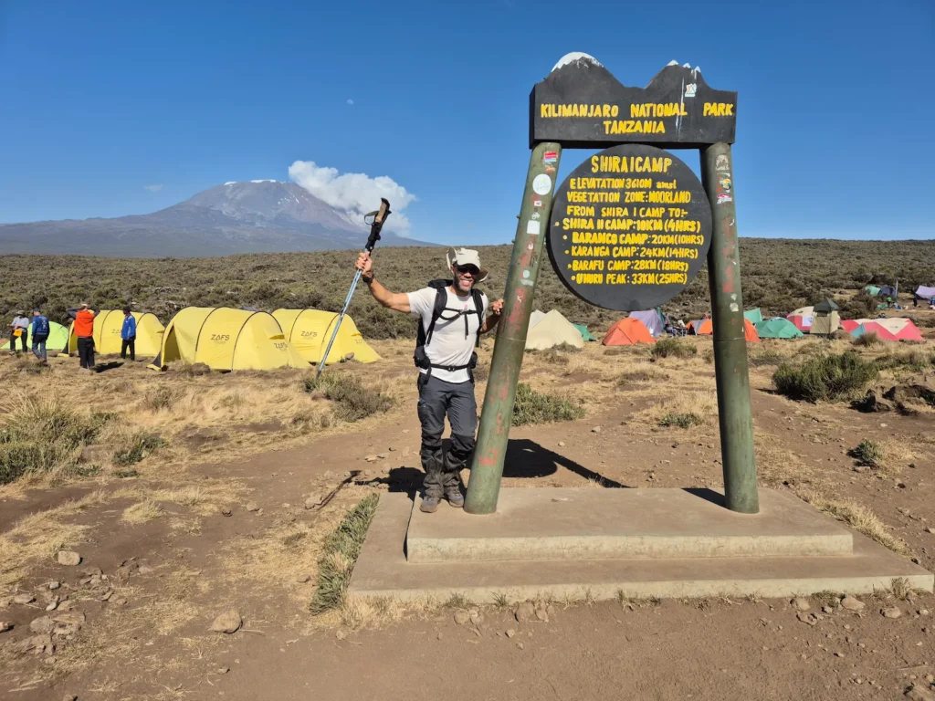 Simon at the Shira 1 Camp sign on Kilimanjaro
