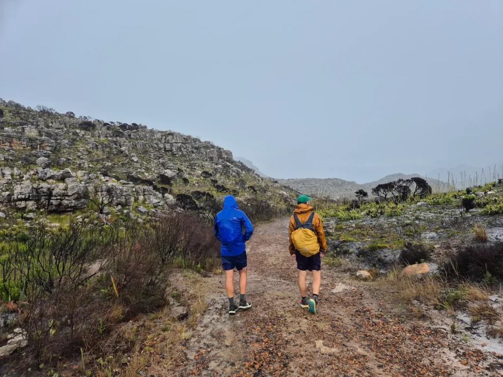 Two hikers on a gravel path near Muizenberg Peak on Table Mountain