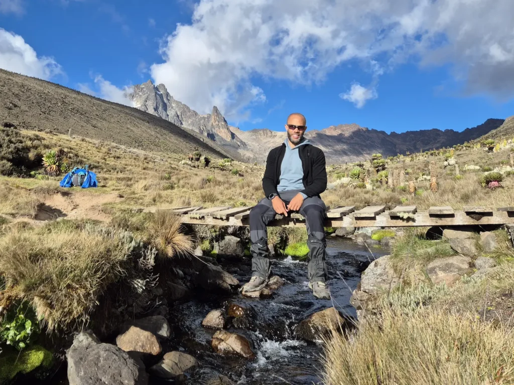 Simon in Teleki Valley with Mount Kenya peaks in the distance