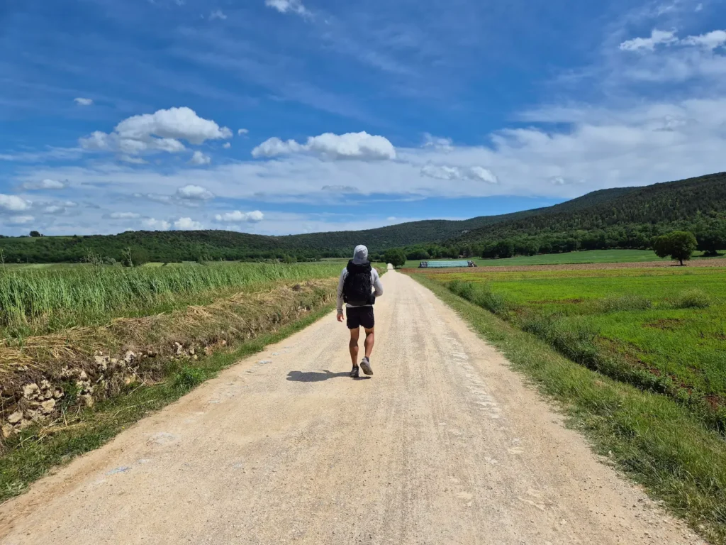 Simon walking along a gravel path in Tuscany