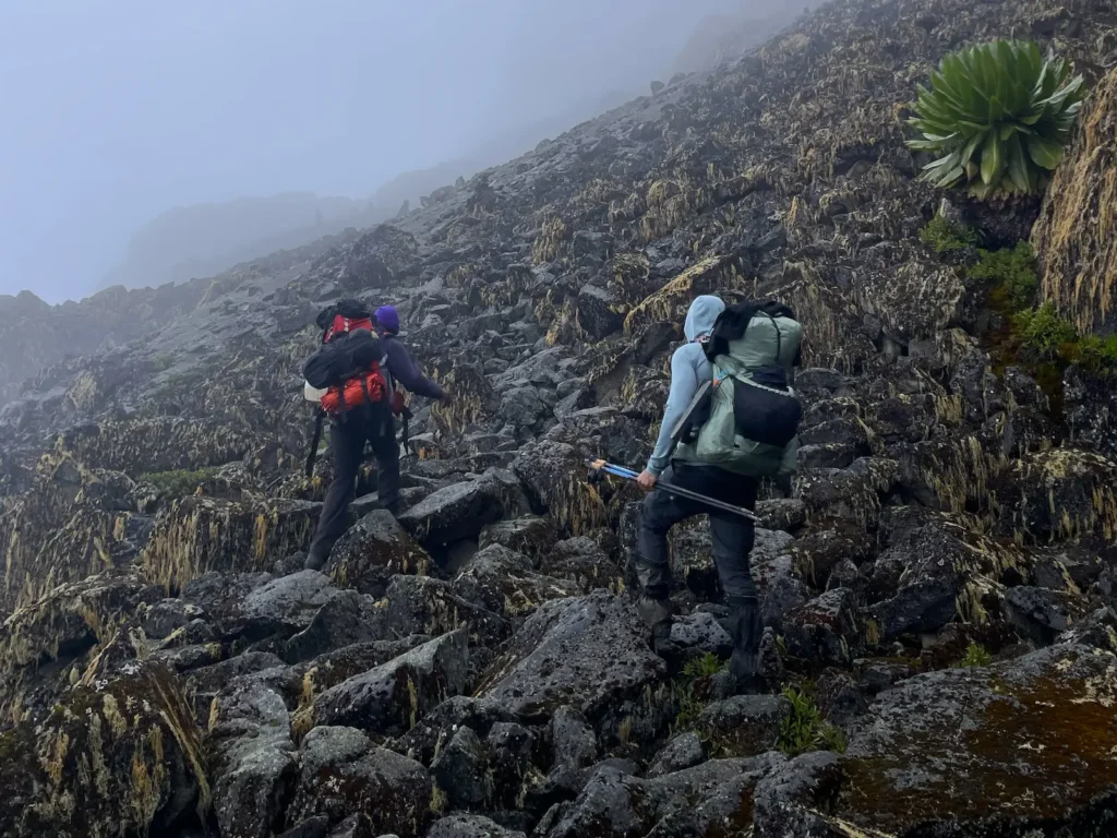 Simon and a guide on rocky terrain on Mount Kenya