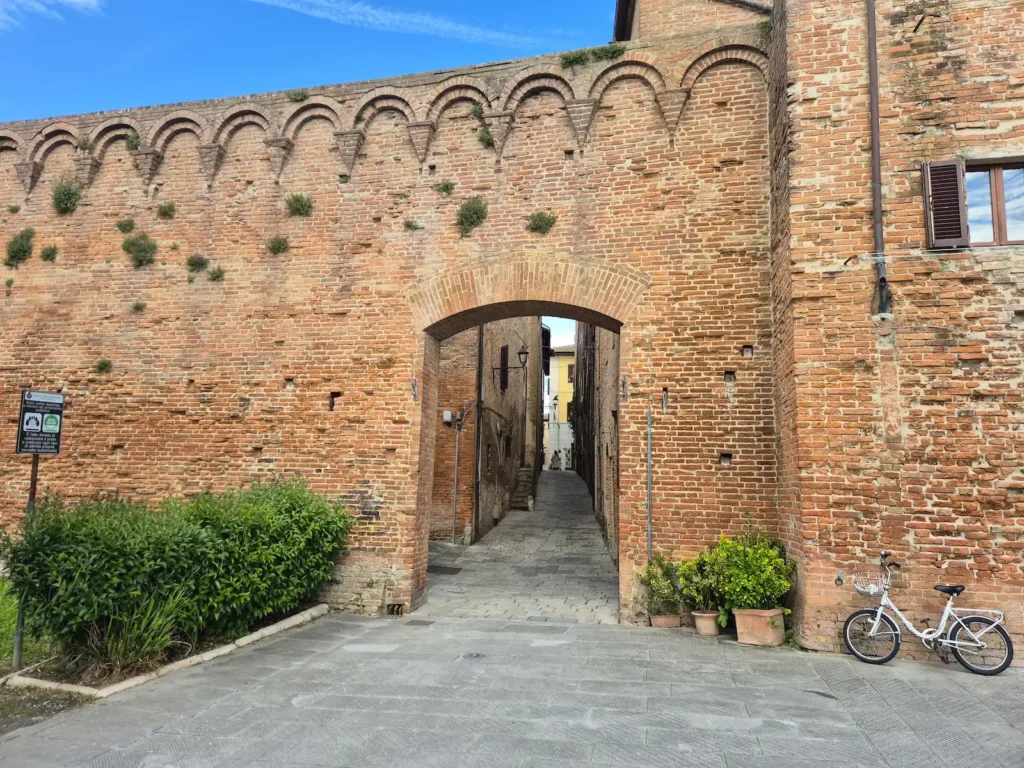 An archway in a section of Buonconvento’s 14th‑century town wall