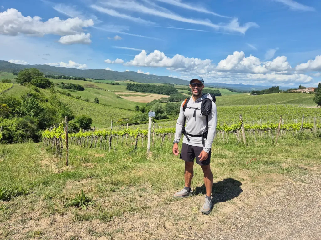 Simon standing in front of a vineyward in Tuscany
