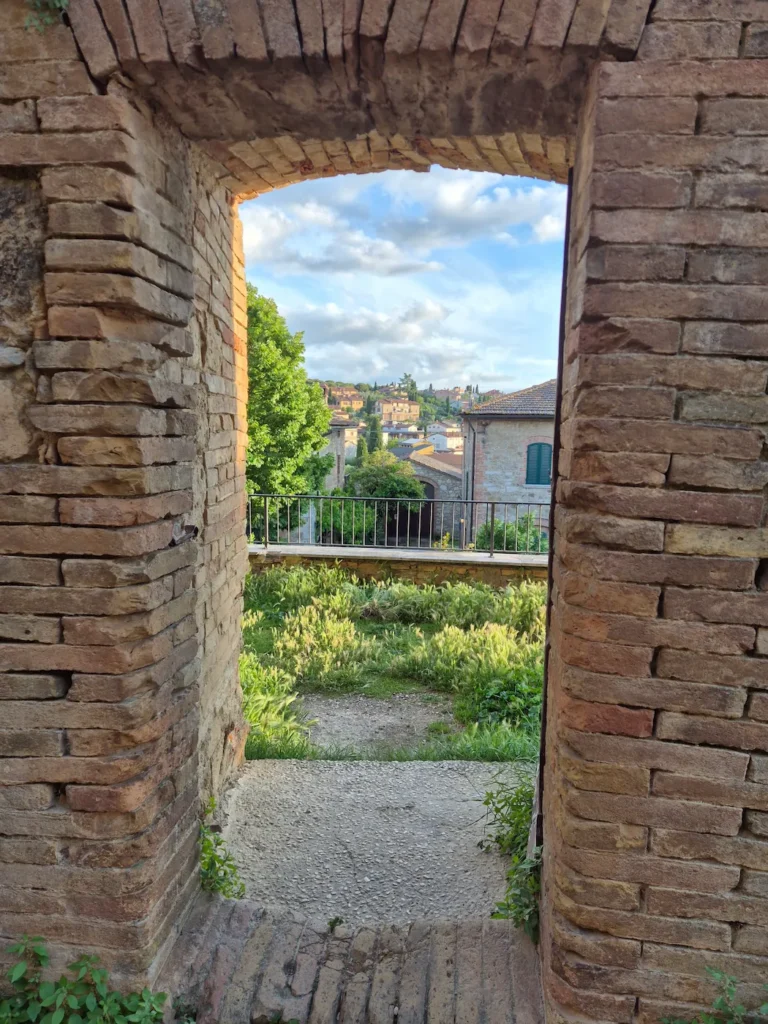 A town view of through a passageway in San Quirico's town wall