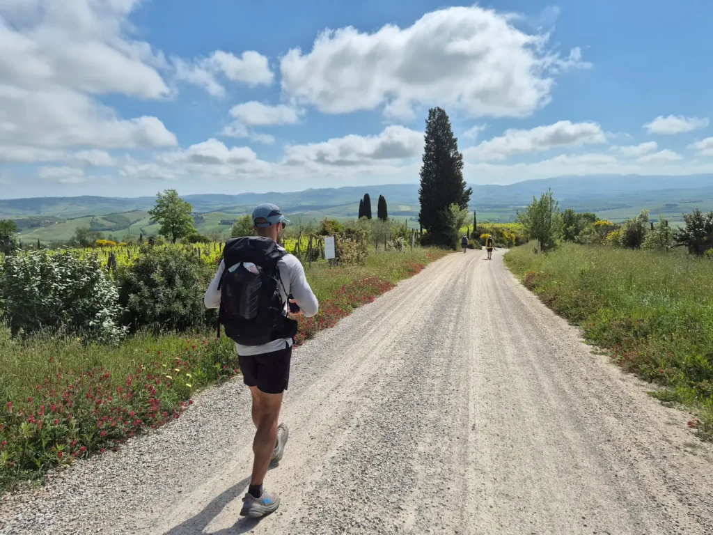 Simon walking along a gravel track in Tuscany