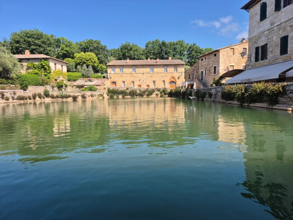 Bagno Vignoni's large thermal pool surrounded by buildings